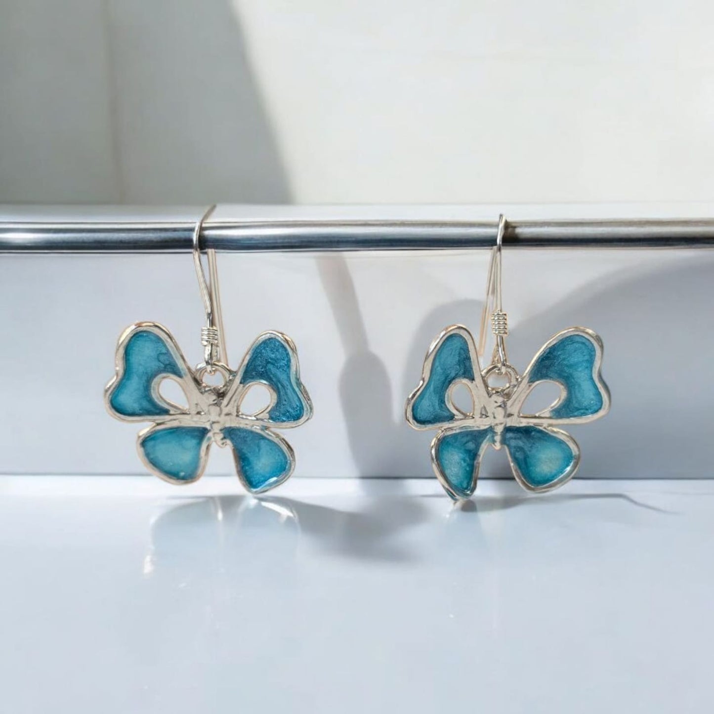 Mariposa Plata, encapsulado azul